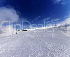 Ski slope in winter mountains