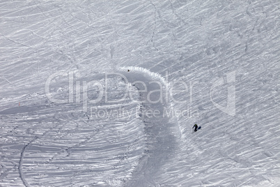 Skier on off-piste slope in sun day