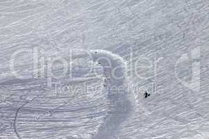 Skier on off-piste slope in sun day