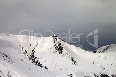 Off-piste slope and gray sky in wind day
