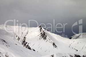 Off-piste slope and gray sky in wind day