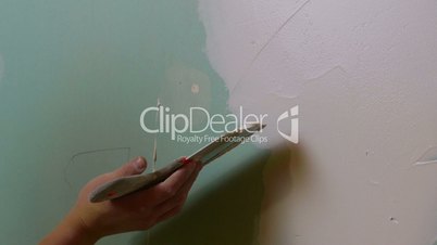 Construction Worker Applying Plaster on a Drywall, closeup