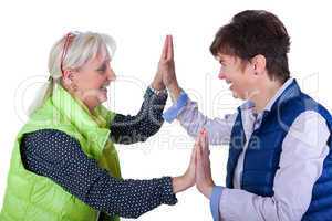 Two middle-aged girlfriends clapping away