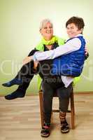 Seated woman holding another woman for fun