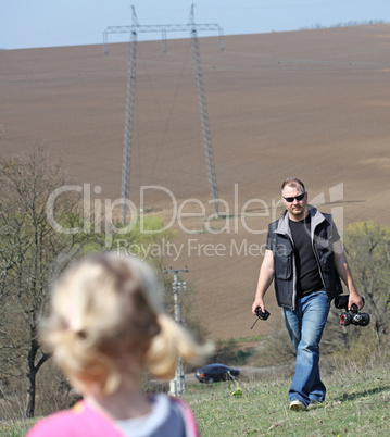 Father and her daughter playing in the nature with a toy car Father and her daughter playing in the nature with a toy car