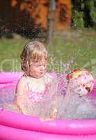 Portrait of little girl enjoying her vacation in the pool outdoors