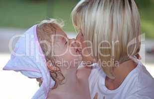 Young mother kissing her daughter