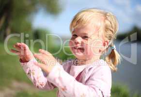 Adorable little girl laughing outside