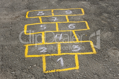 Childish game hopscotch on asphalt