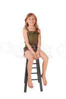 Girl sitting on high chair.