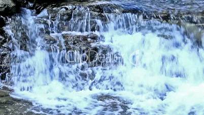 Beautiful veil cascading waterfall, mossy rocks