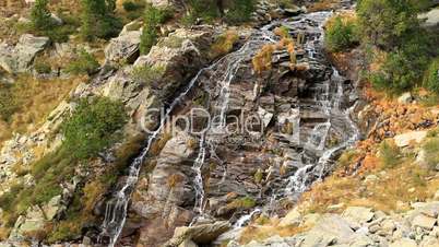 Beautiful veil cascading waterfall, mossy rocks