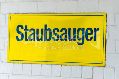 Staubsauger, gelbes Schild