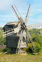 wooden windmill against the blue sky