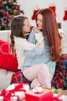 Festive mother and daughter on the couch