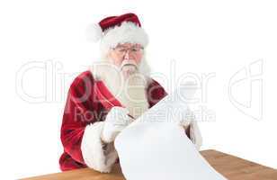 Santa writes something with a feather