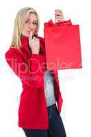 Festive blonde holding red gift bag