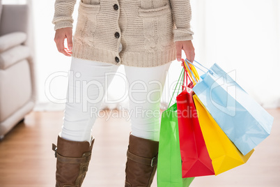 Mid section of woman holding shopping bags