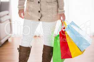 Mid section of woman holding shopping bags