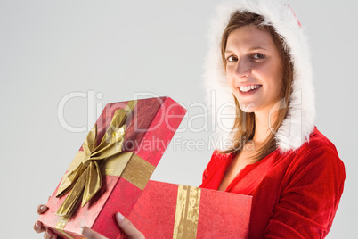 Smiling girl opening a gift and looking at the camera