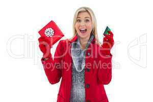 Festive blonde holding gift and credit card