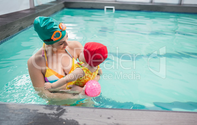 Pretty mother and baby at the swimming pool