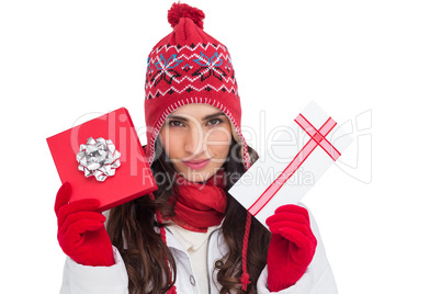 Festive brunette in winter clothes showing gifts