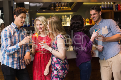 Happy friends having a drink together