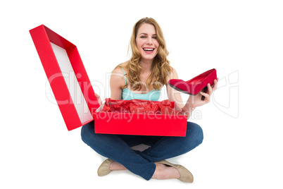 Smiling young woman showing her new shoes