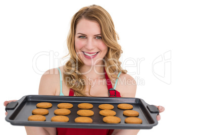 Smiling woman showing hot cookies