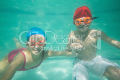 Cute kids posing underwater in pool