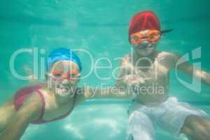 Cute kids posing underwater in pool