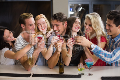 Happy friends having a drink together