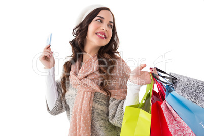 Beauty brunette holding credit card and shopping bags
