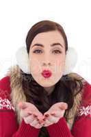 Festive brunette with lipstick blowing a kiss
