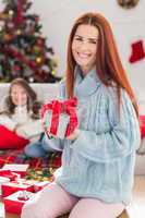 Festive mother holding a gift