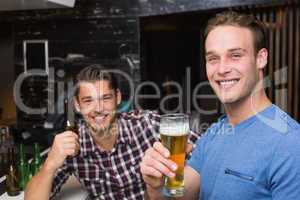 Young men drinking beer together