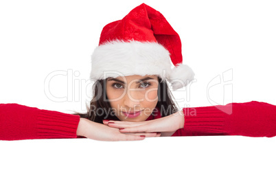 Pretty brunette in santa hat smiling at camera