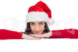 Pretty brunette in santa hat smiling at camera