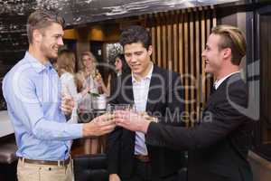 Handsome friends having a drink together