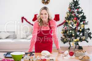 Festive blonde making christmas cookies