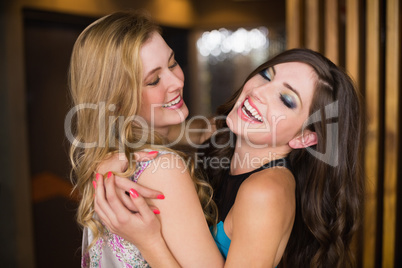 Attractive friends hugging and smiling