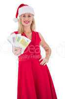 Festive blonde in red dress showing her cash