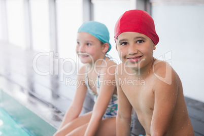 Cute little kids sitting poolside