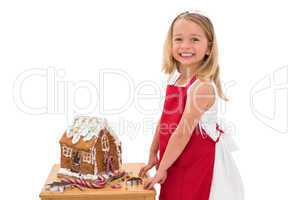 Festive little girl making gingerbread house