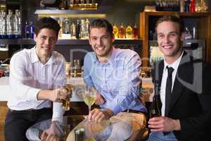 Handsome friends having a drink together