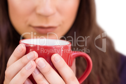 Close up of a festive brunette holding a mug