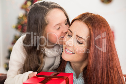 Daughter giving her mother a christmas present