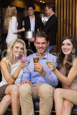 Happy friends having a drink together