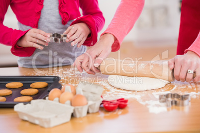 Festive mother and daughter making christmas cookies